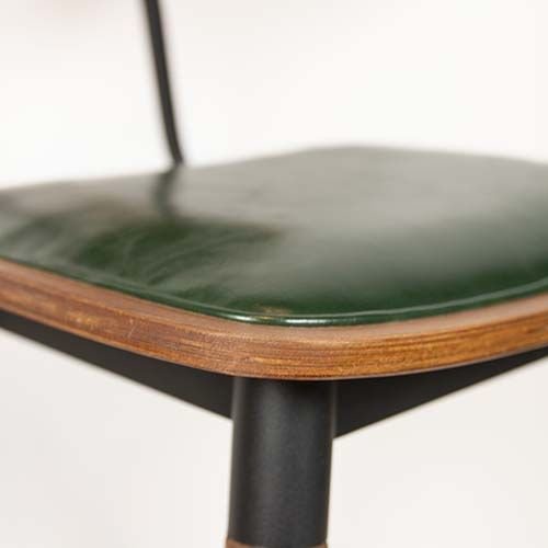 "Studo" bar stool made of green synthetic leather and frame made of oak and metal