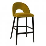 "Jyll" bar stool made of yellow gold velvet and legs made of black solid beech